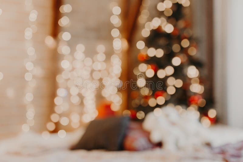 Christmas home room with tree and festive bokeh lighting, blurred holiday background