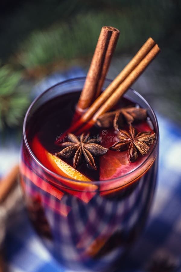 Christmas hot mulled wine in a glass with spices and citrus fruit. Mulled wine with cinnamon, anise and orange