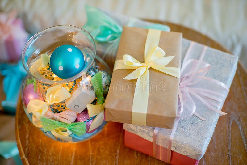 Árbol de navidad regalos junto a una cama, piso lámpara, martillado hierro sillas a mesa.