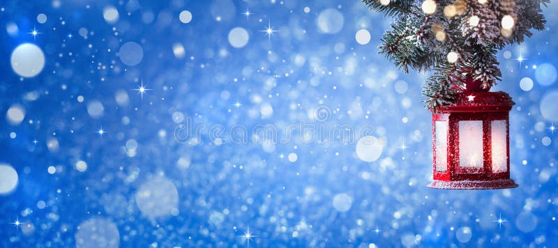 Christmas lantern hanging on snow covered fir branches. Winter cozy scene. Banner stock photo
