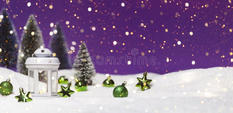 Christmas lantern with tree in snow. Glowing festive garland on purple background. Cozy fairytale atmosphere with home. Decor. Selective focus in the foreground