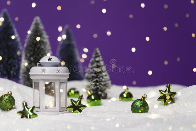 Christmas lantern with tree in snow. Glowing festive garland on purple background. Cozy fairytale atmosphere with home