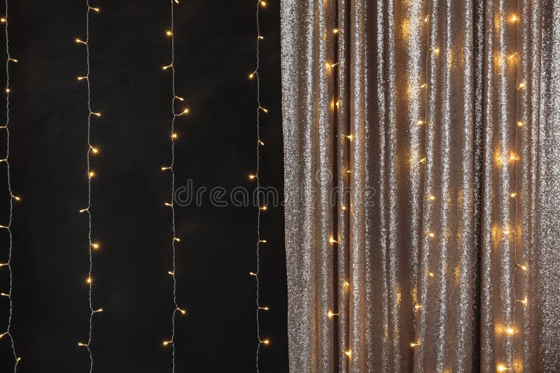 Christmas Lights Burning on a White Wooden Background. New Year Back