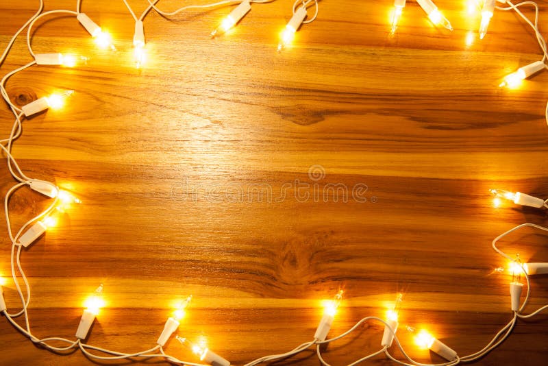Christmas lights frame on golden wooden stock image