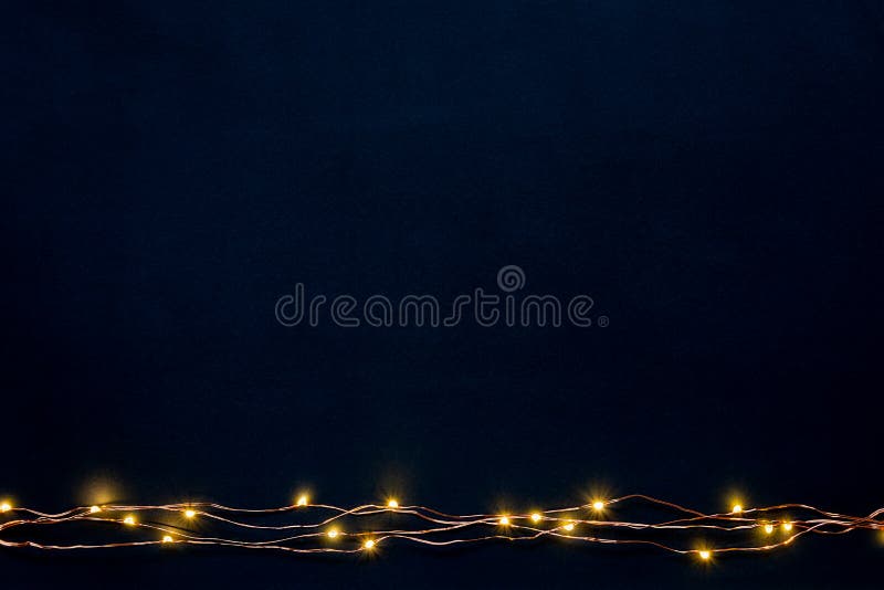 Christmas lights garland border over black background. Flat lay, copy space. stock image Christmas lights garland border over black background. Flat lay, copy space. stock image