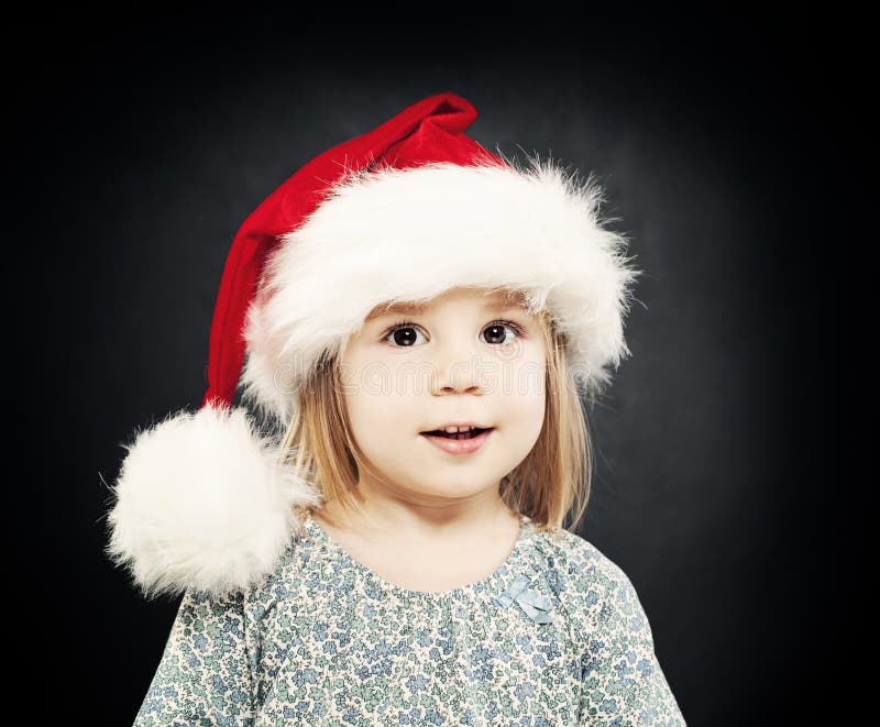 Christmas Little Girl. Smiling Child in Santa Hat Stock Photo - Image ...
