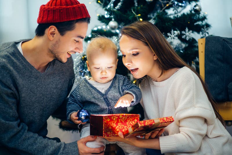 Christmas magic gift box and happy parents and Child baby