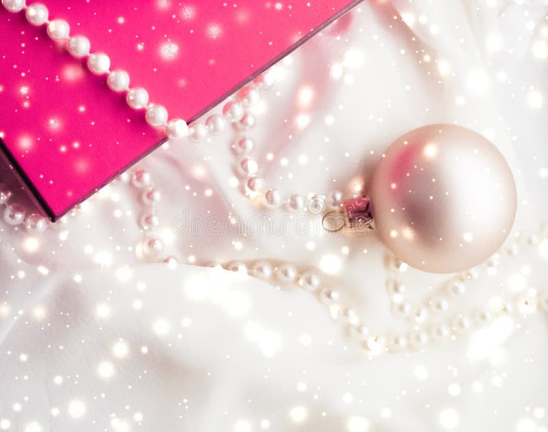 Christmas magic holiday background, festive baubles, pink vintage gift box and golden glitter as winter season present for luxury stock photography Christmas magic holiday background, festive baubles, pink vintage gift box and golden glitter as winter season present for luxury stock photography