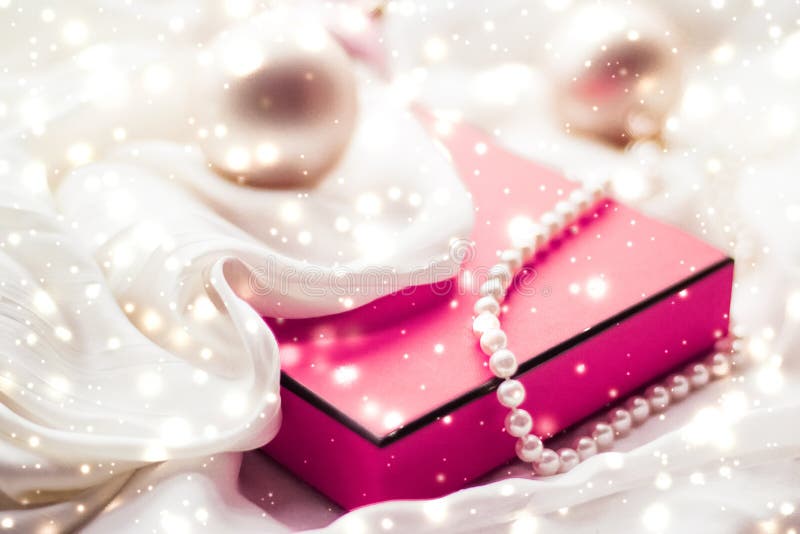 Christmas magic holiday background, festive baubles, pink vintage gift box and golden glitter as winter season present for luxury stock photography Christmas magic holiday background, festive baubles, pink vintage gift box and golden glitter as winter season present for luxury stock photography