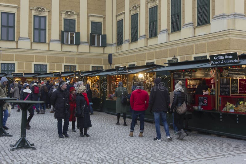 Christmas market in the forecourt of Schonbrunn palace. VIENNA, AUSTRIA - JANUARY 2 2016: Christmas market in the forecourt of Schonbrunn palace, with people royalty free stock photography Christmas market in the forecourt of Schonbrunn palace. VIENNA, AUSTRIA - JANUARY 2 2016: Christmas market in the forecourt of Schonbrunn palace, with people royalty free stock photography