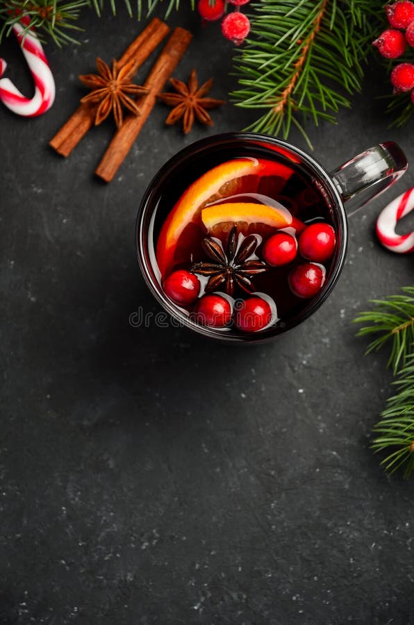 Christmas Mulled Wine with Orange and Cranberries. Holiday Concept Decorated with Fir Branches and Spices.