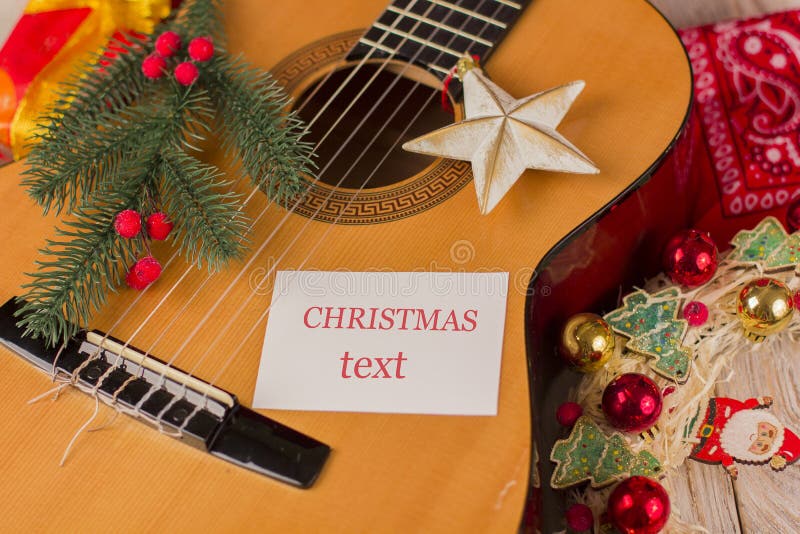 Christmas music card background with guitar and holiday winter d