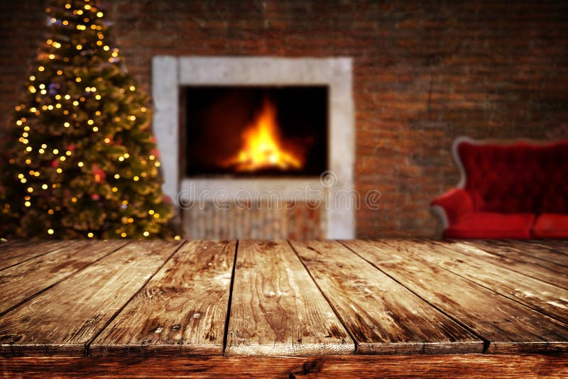 Christmas and New year background with empty dark wooden deck table over christmas tree and blurred light bokeh. Empty display for product montage. Rustic vintage Xmas background.