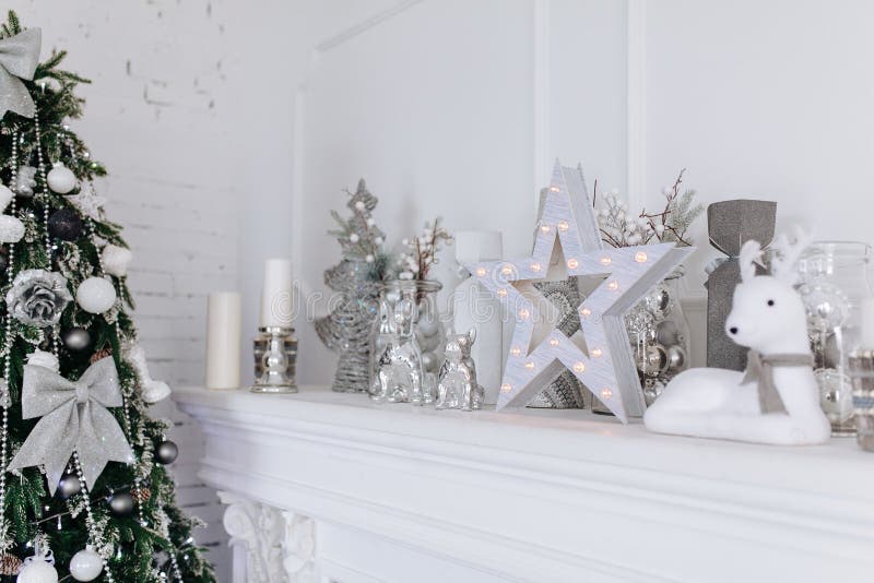 Christmas and New Year White and Silver Decorations on Fireplace