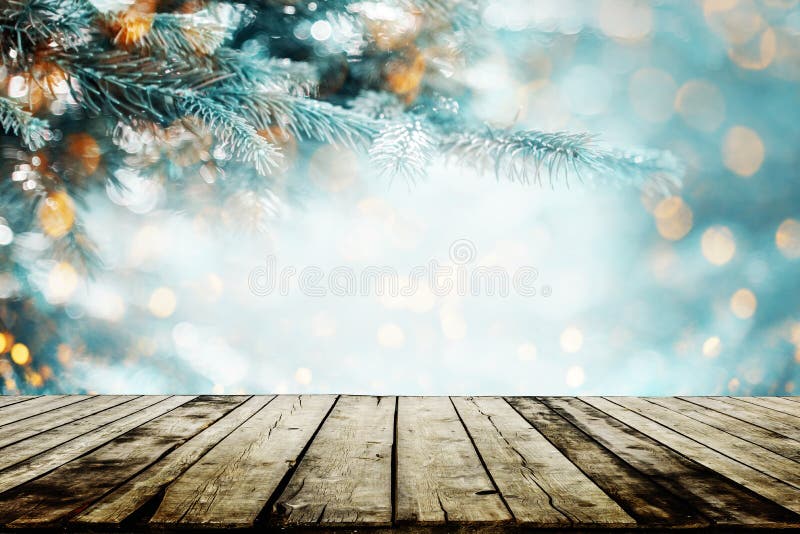 Christmas, new year and winter holiday background with empty wooden table for product display. Christmas lights on winter conifer