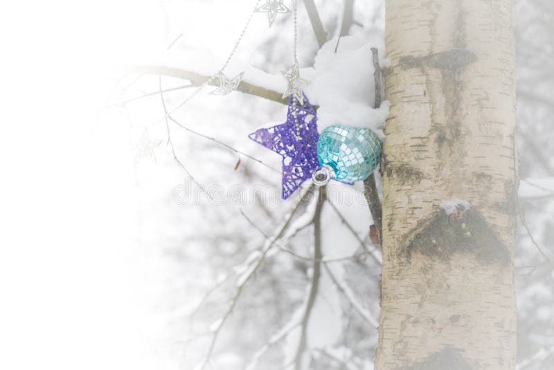 Christmas ornaments on a tree in a snowy forest after a snow storm, depicting, winter time, cold weather, Christmas