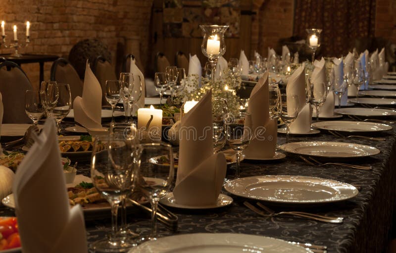 Luxurious romantic party table setting lit by candles. Luxurious romantic party table setting lit by candles