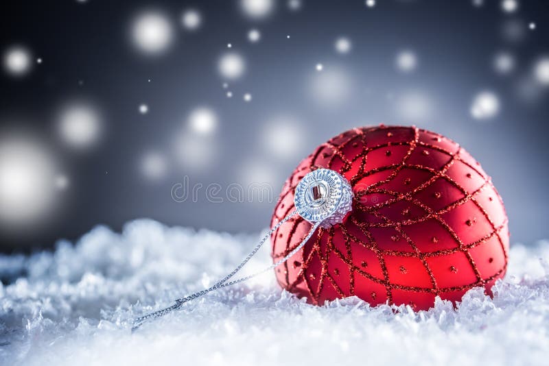 Christmas red Luxury ball in snow and abstract snowy atmosphere