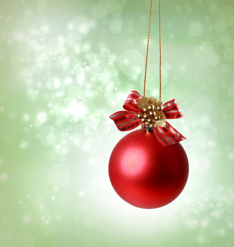 Christmas red ornaments over green tree lights background