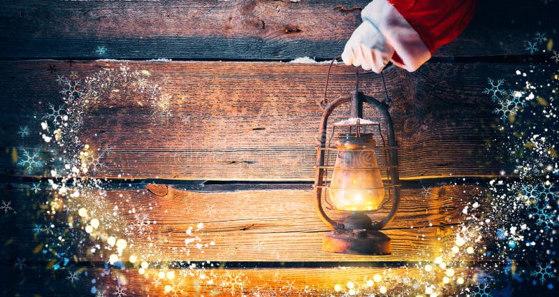 Christmas scene. Santa Claus hand holding vintage oil lamp royalty free stock photos Christmas scene. Santa Claus hand holding vintage oil lamp royalty free stock photos