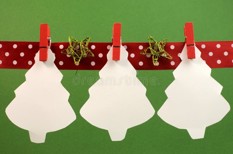 Christmas and seasonal holidays bunting with white Christmas treas hanging from pegs on a line with copy space