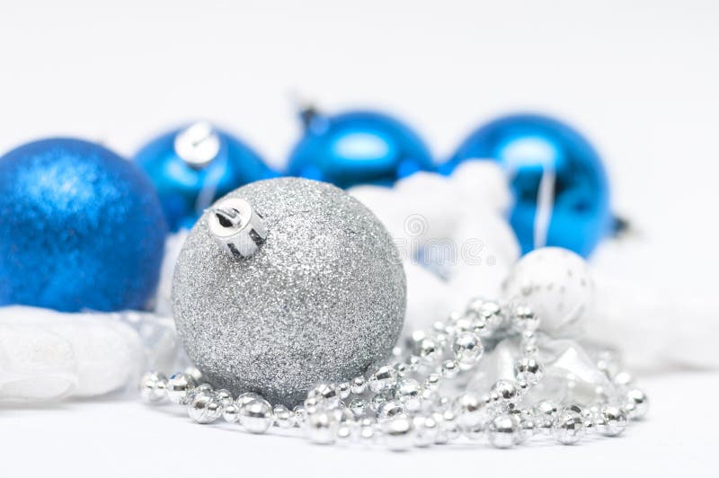 Christmas silver ball in focus and blue balls in background wi