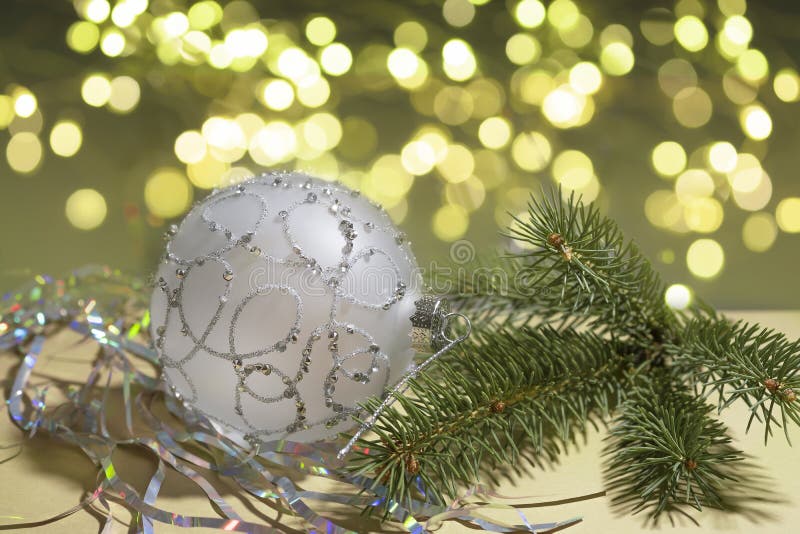 Christmas Silver Ball and Twig of Christmas Tree on Background with