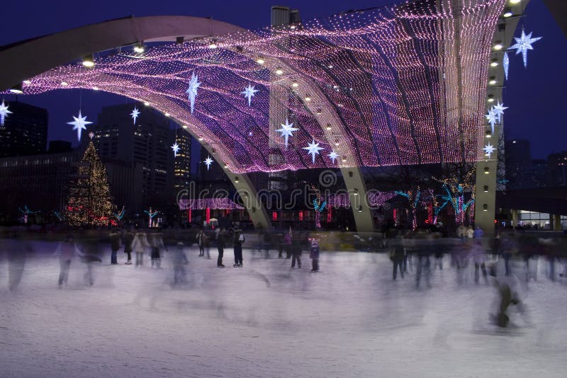 Christmas day, skaters at Toronto city hall ice rink. Christmas day, skaters at Toronto city hall ice rink