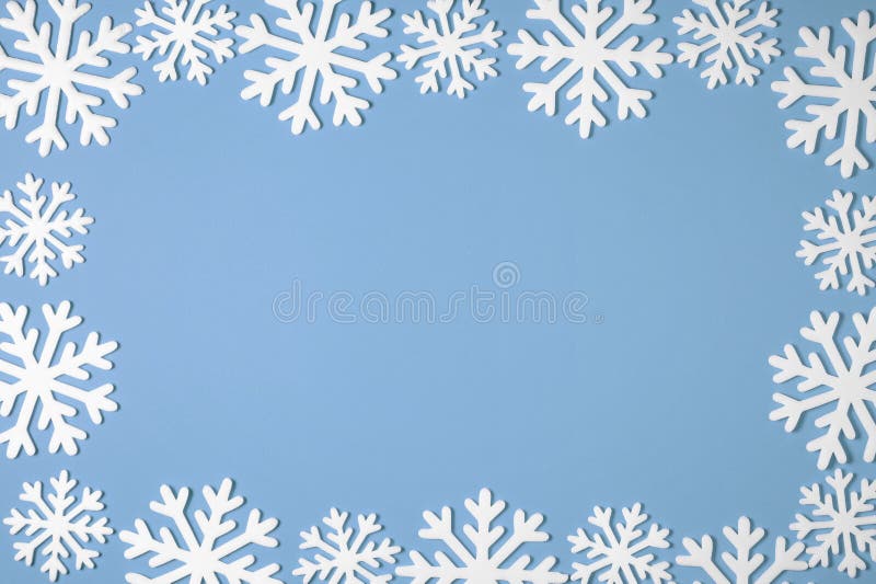 Christmas snowflake border frame on blue background. Xmas minimal texture with copy space. top view