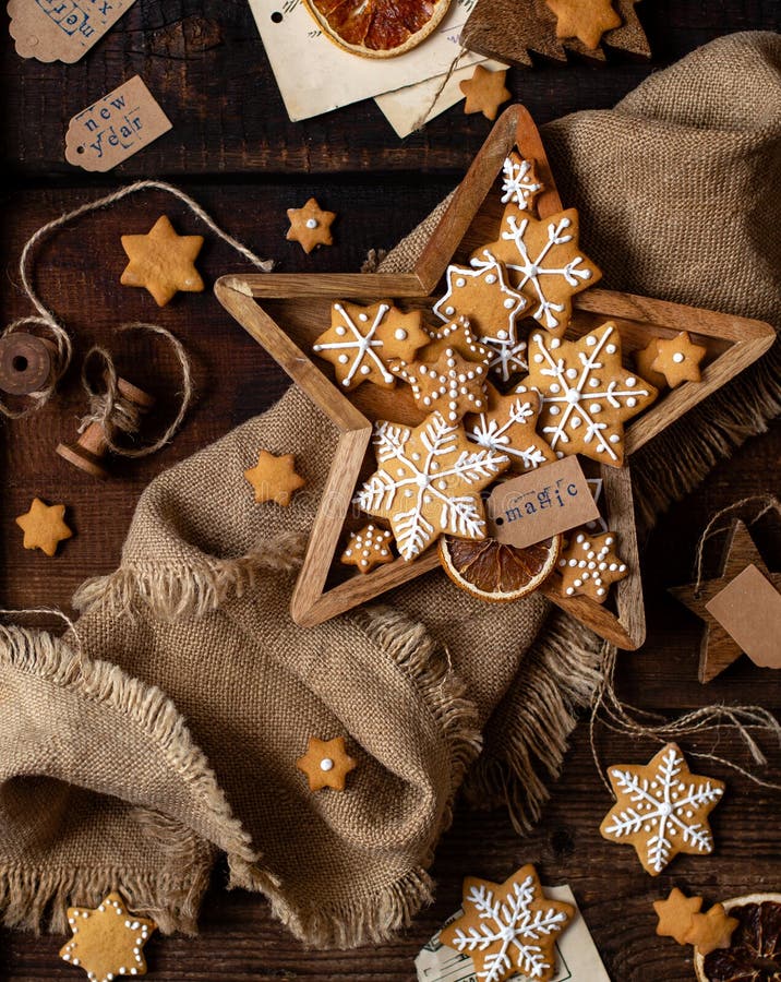 Christmas snowflakes shaped orange cookies with beautiful icing decoration