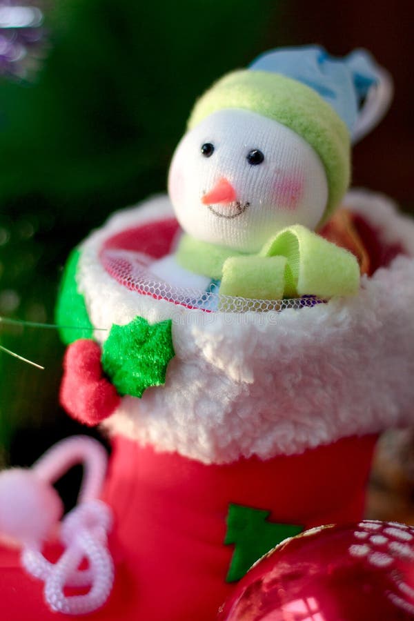 Christmas snowman sitting inside red christmas boot. stock image