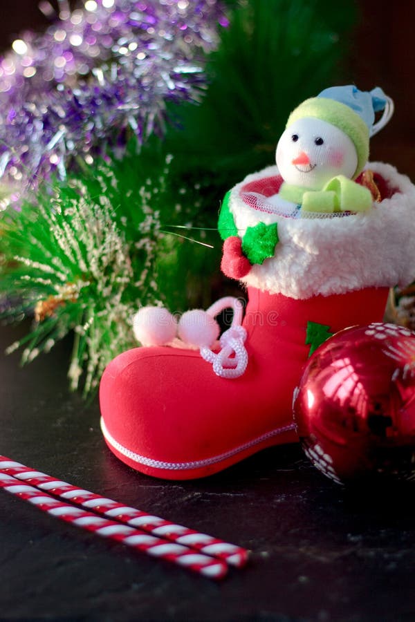 Christmas snowman sitting inside red christmas boot. stock photos