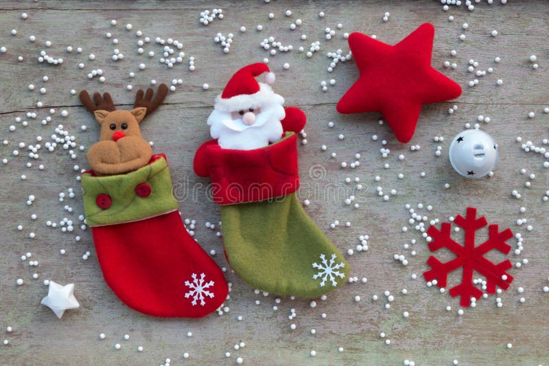 Christmas socks and Christmas decoration on white wooden background