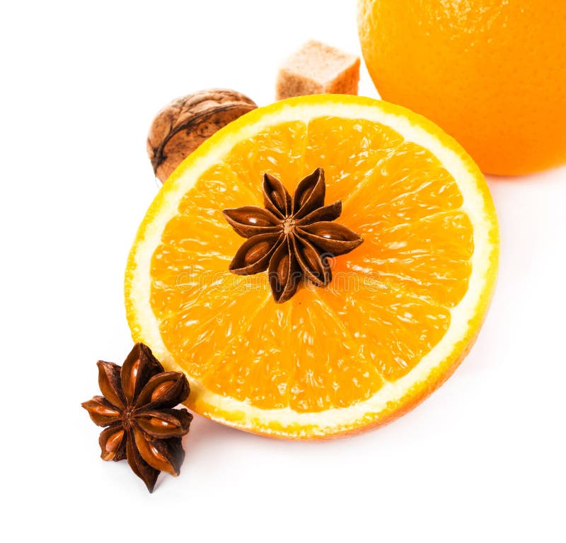 Christmas spices for hot mulled wine isolated on white background with Anise star, Cinnamon stick and fresh orange, closeup.