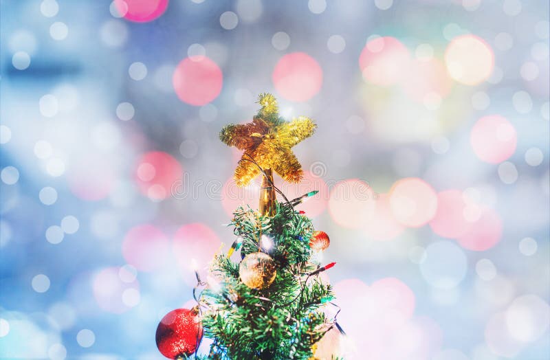 Christmas star on Christmas tree, soft Bokeh lights backgrounds