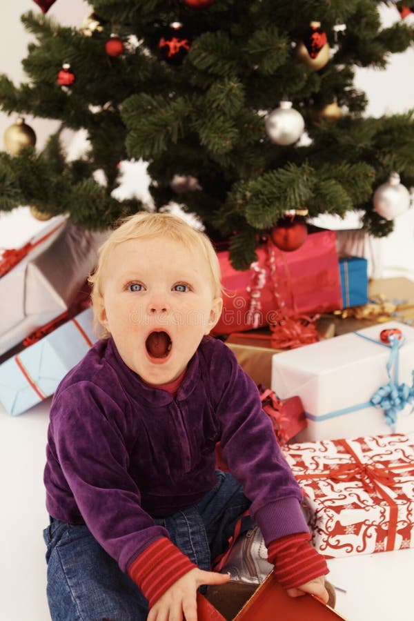 Christmas - Surprised child opening gifts