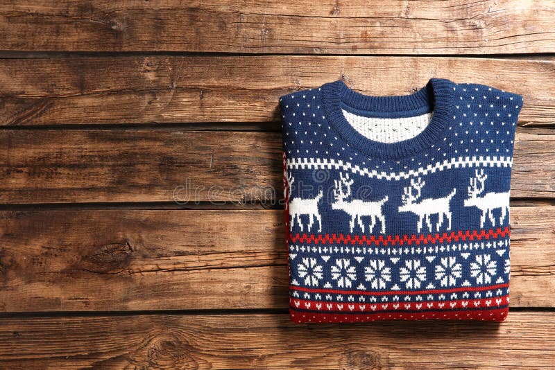 Christmas Sweater with Pattern and Space for Text on Wooden Background ...