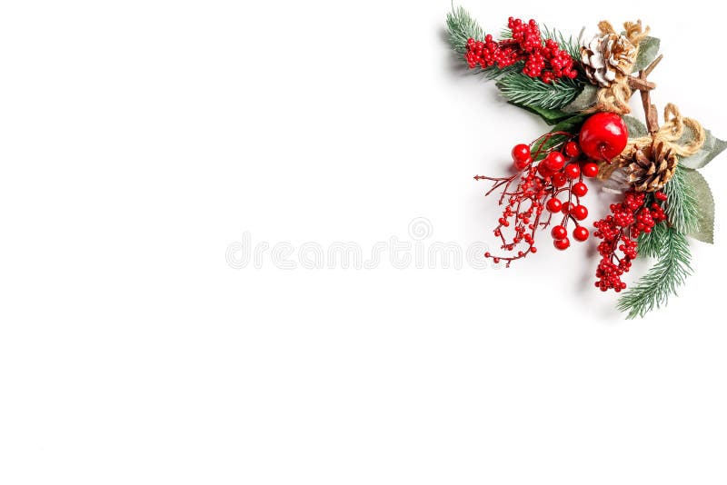 Christmas template. Fir tree branches, cones, red berry and decorations on white background. Christmas and new year composition