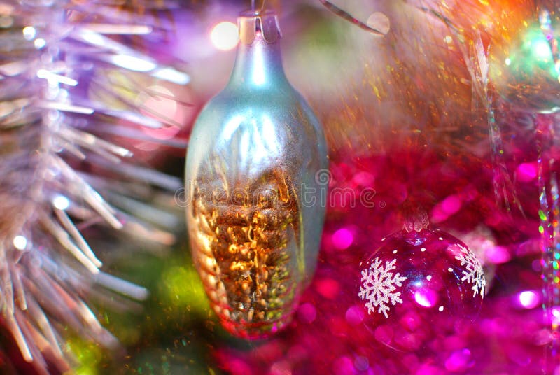 Christmas toy in the form of corn on a background of a bright sparkling multi-colored tinsel