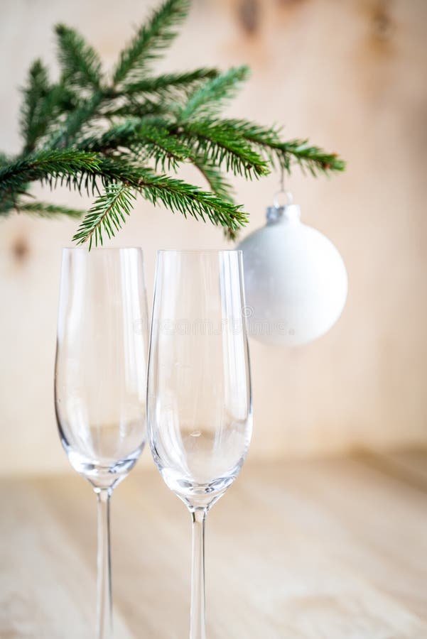 Christmas tree branch with empty champagne glasses