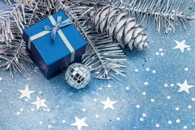 Christmas tree branches with cones, decorations and blue gift bo royalty free stock images Christmas tree branches with cones, decorations and blue gift bo royalty free stock images