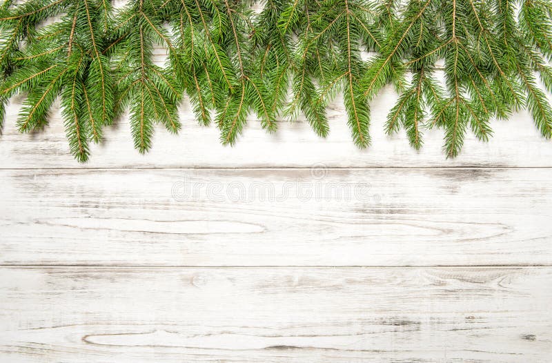 Christmas tree branches on wooden texture. Winter holidays royalty free stock photo Christmas tree branches on wooden texture. Winter holidays royalty free stock photo