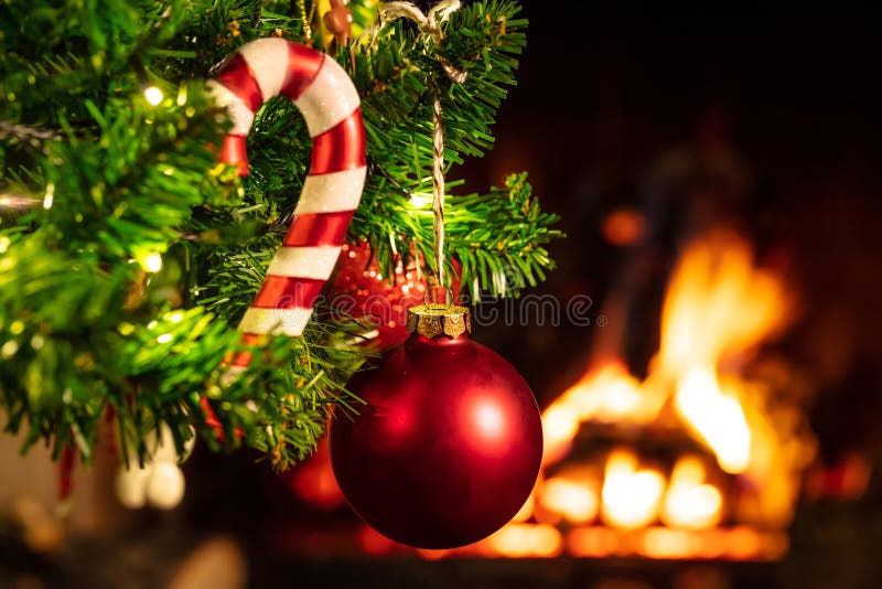 Christmas Tree Close Up on Blurred Burning Fireplace Background Stock