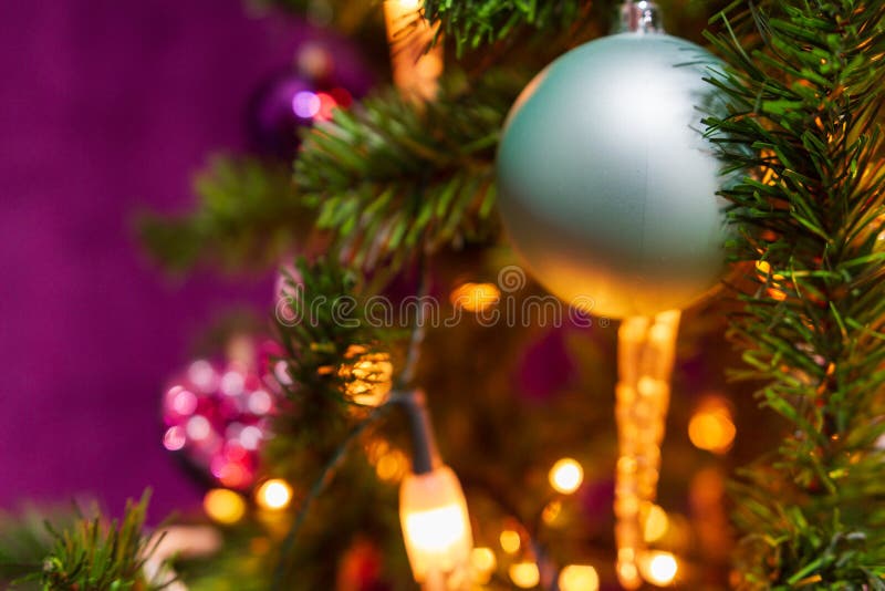 Christmas Tree Decorated in a Purple Theme with a Prominent Cyan Stock ...