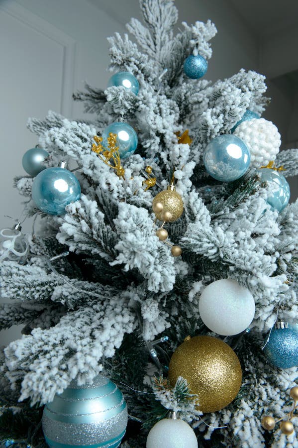 Christmas Tree Decorated with Yellow and White Balls and Tinsel. Stock