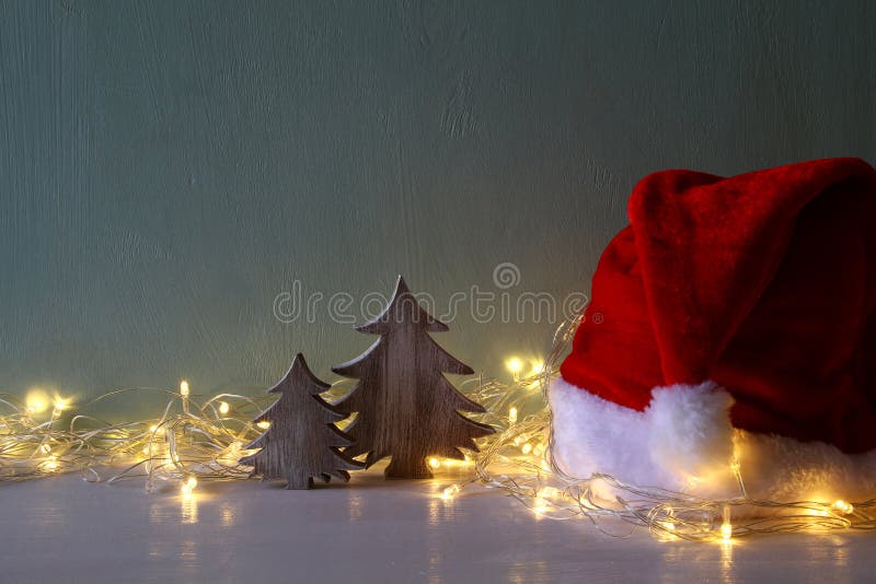 Christmas Tree with Garland Lights Next To Santa Hat Stock Photo ...