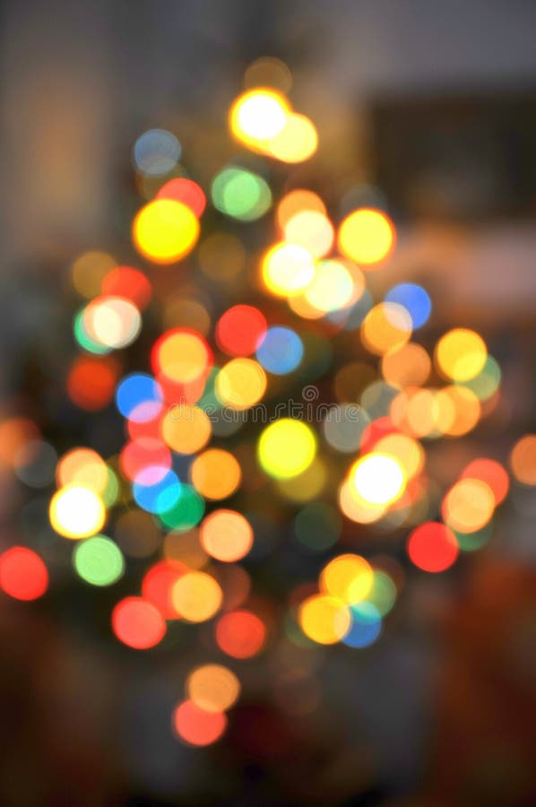 Shape of a Christmas tree defined by blurry colorful lights. Shape of a Christmas tree defined by blurry colorful lights