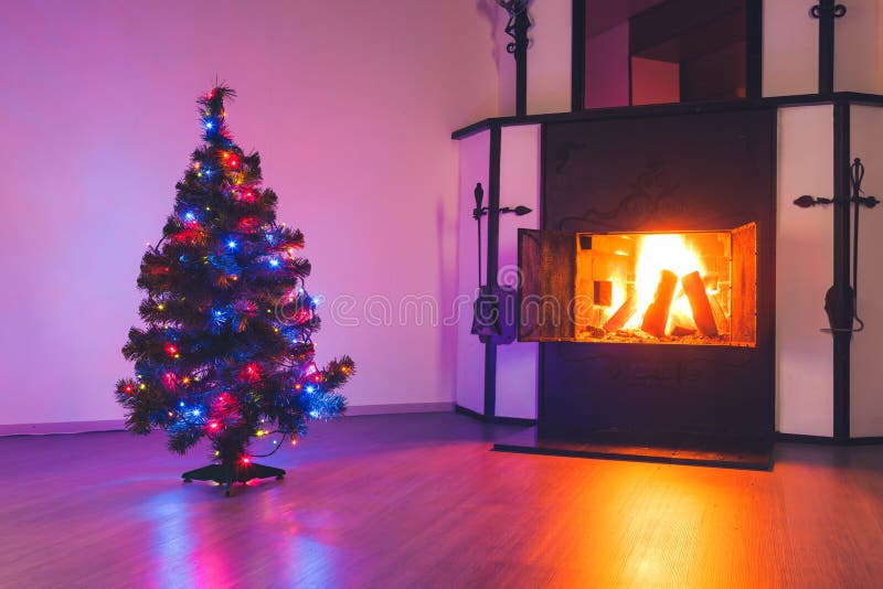 Christmas tree with lights garland and fireplace