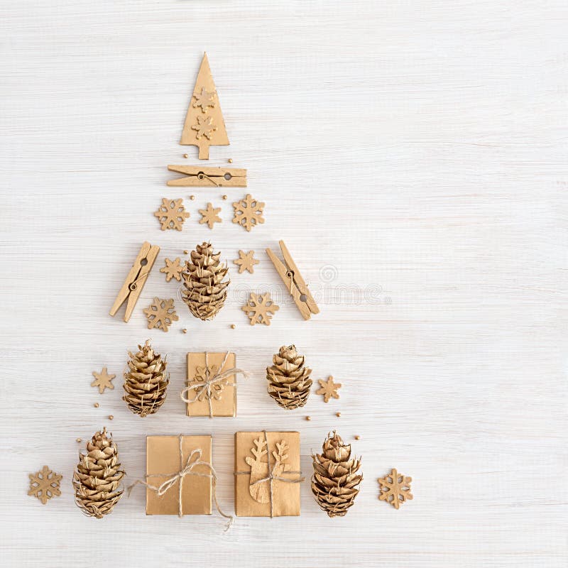 Christmas tree made from golden winter decorations on a white table