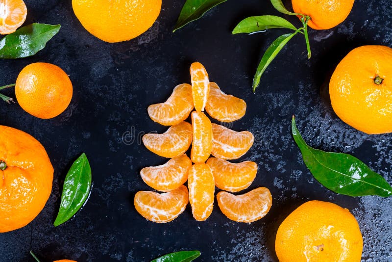 Christmas tree make with tangerines on dark rustic background, top view, festive greeting card stock photos Christmas tree make with tangerines on dark rustic background, top view, festive greeting card stock photos